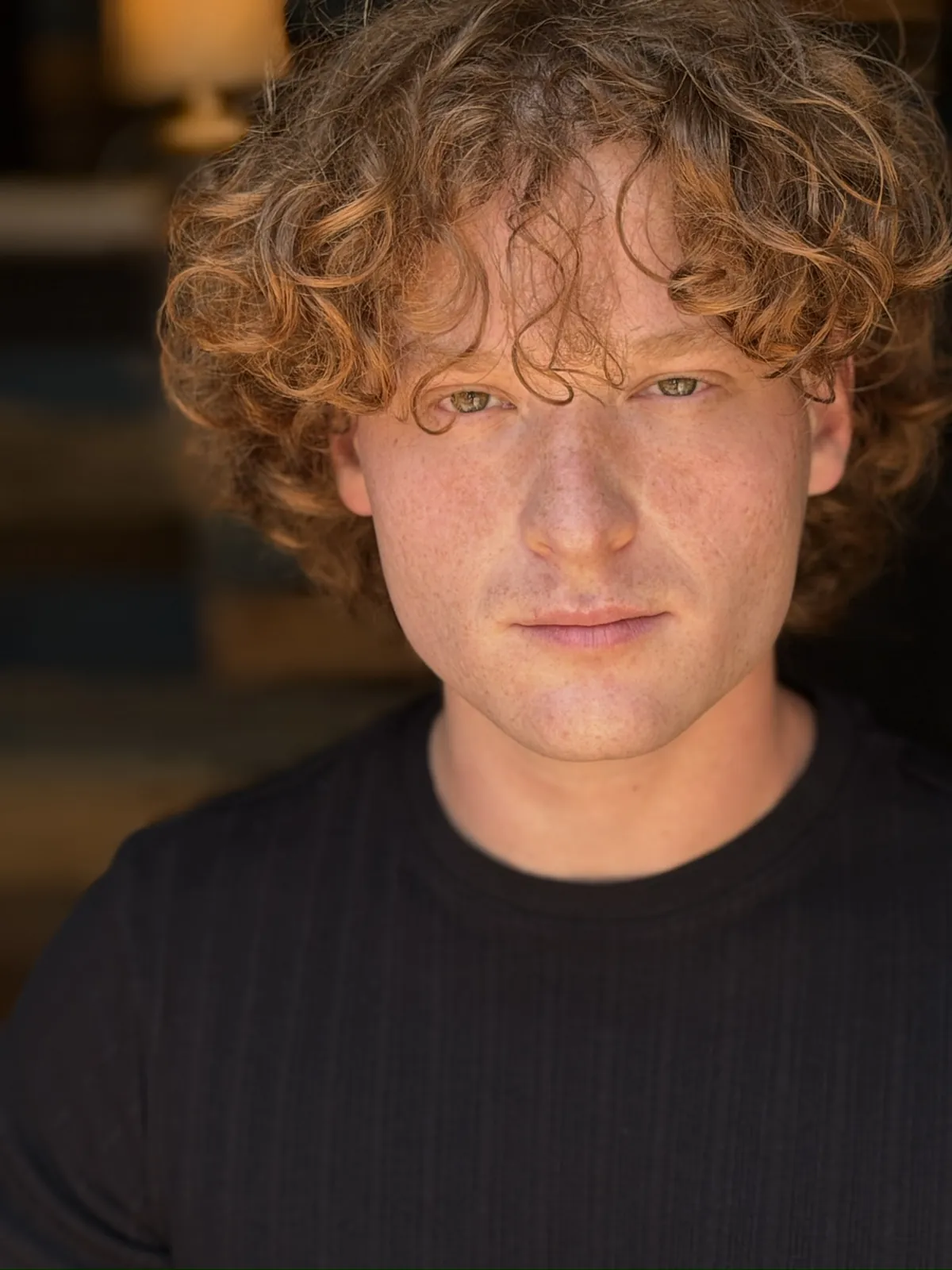 Theatrical headshot in a black shirt